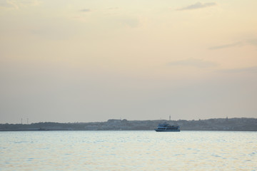 Obraz premium Evening scenery of sunset over the sea and mountains. Sea evening landscape with clouds