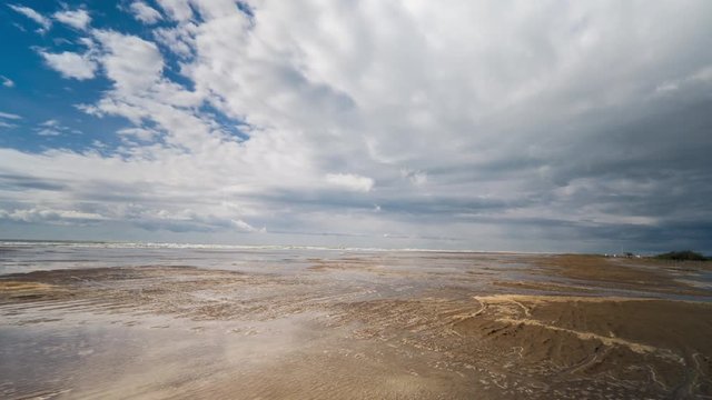 pov shot with a camera attached to the front of an off road vehicle driving over a flooded beach in the delta d'ebro park, spain