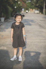 asian children with school backpack toothy smiling outdoor