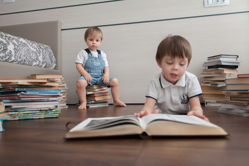 Fototapeta na wymiar Books on the floor. The children are reading.