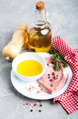 Fresh raw pork chops with spices and herbs