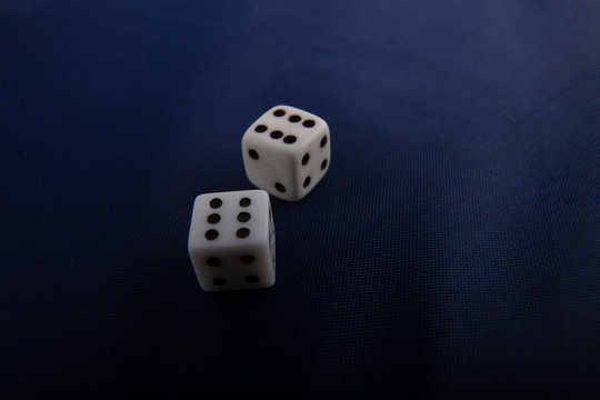 Two game dices, casino symbol on blue cloth