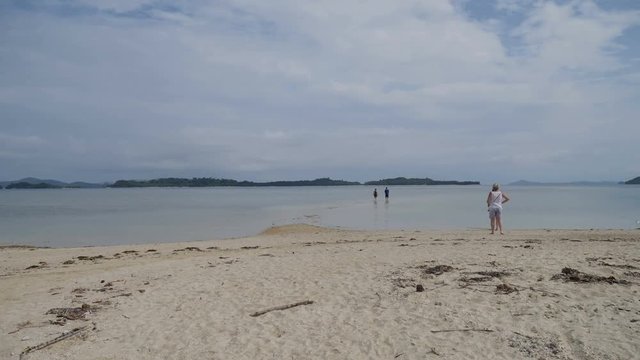 Tourists arriving on starfish island on small beach by boat