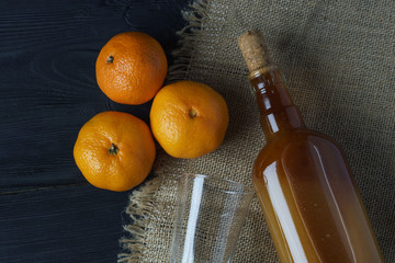 Homemade tangerine  tincture on wooden table