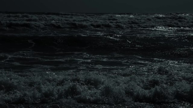 boiling waves at night in the moonlight close