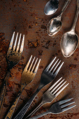 Vintage cutlery set on rusted background
