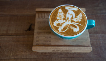 Closeup latte art of coffee white cup on wooden table surface