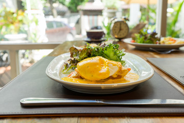 omelet with ham tomato and green salad healthy and a cup of coffee for breakfast