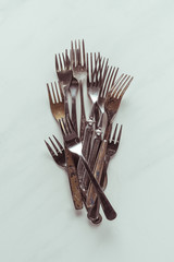 Old metal forks on white background