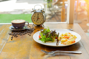 omelet with ham tomato and green salad healthy and a cup of coffee for breakfast