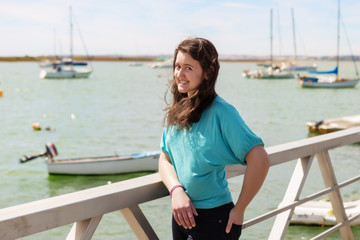 Fototapeta na wymiar Emotional portrait of a girl on a dock near the sea. Portugal