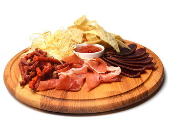 Snack to beer on a wooden board. Basturma, dried meat, dried squid, chips isolated on white background.