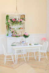 kitchen dining room with flowers and white furniture