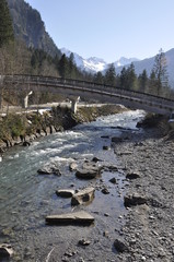 Bridge over river with mountain landscape