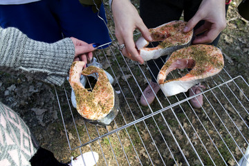Preparation of trout in spices to roast on barbecue outdoor.
