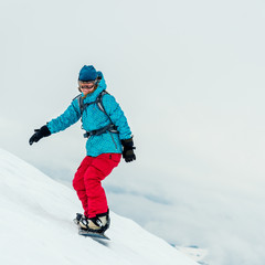 Young woman on the snowboard