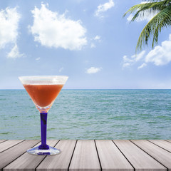 Cocktail glasses with sea background.
