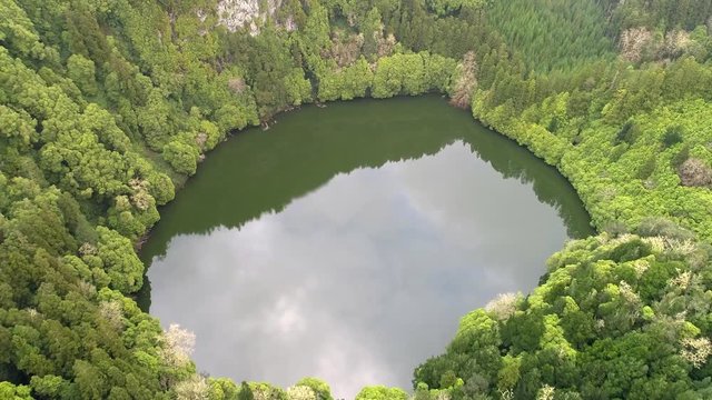 Lake in volcanic crater Lagoa do Congro, San Miguel Island, Azores, Portugal. Aerial shot. 4K, UHD
