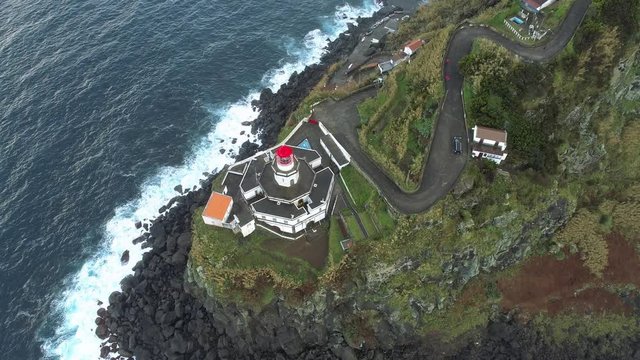 Lighthouse on a rocky promontory. Bird's eye view.
