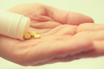 Tablets with a package in the palm of a close-up.