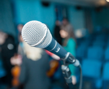 Microphone over blurred meeting room