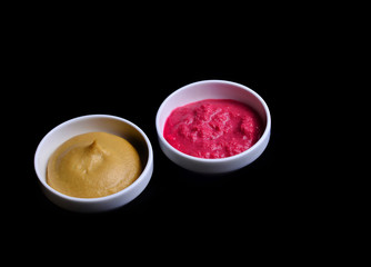 Horseradish and mustard on a black background..