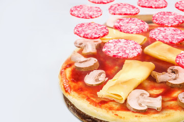 Concept of flying ingredients with pizza dough, isolated on white background.