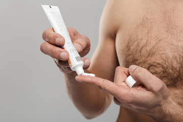 Cropped photo of handsome mature man with cream.