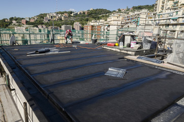 laying of waterproofing sheathing  and insulation during the renovation of a roof in Italy