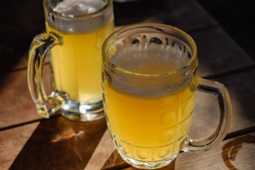 Close-up two cold beers with foam and drops.