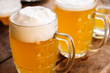 Close-up two cold beers with foam and drops.