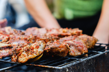 BBQ Roasted Pork Meat With herb spice On The Hot Charcoal Grill With Smoke.