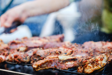 BBQ Roasted Pork Meat With herb spice On The Hot Charcoal Grill With Smoke.