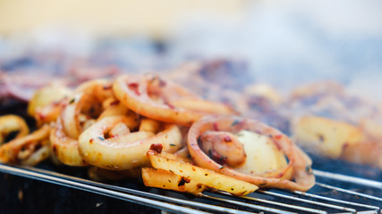 BBQ Roasted Pork Meat With herb spice On Hot Charcoal Grill With Smoke.