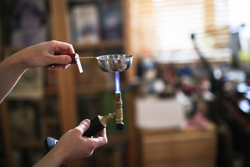 Home workshop girl master on gas burner boil water