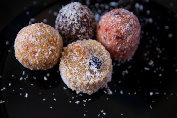 sweets without sugar, with grated dried fruits and nuts, sprinkled with coconut shavings, proper nutrition