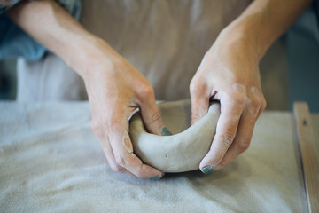 Hands make clay from various items for home and sale in the store and at the exhibition, ceramic...