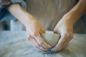 Hands make clay from various items for home and sale in the store and at the exhibition, ceramic...