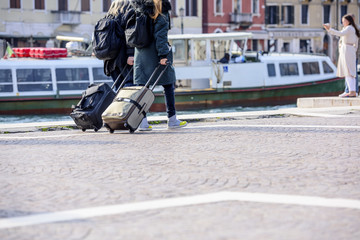Tourists with suitcases in Venice