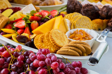 Fruit Salad and cheese board - Crackers with cheese and various fruit for catering at Spring Festival picnic event