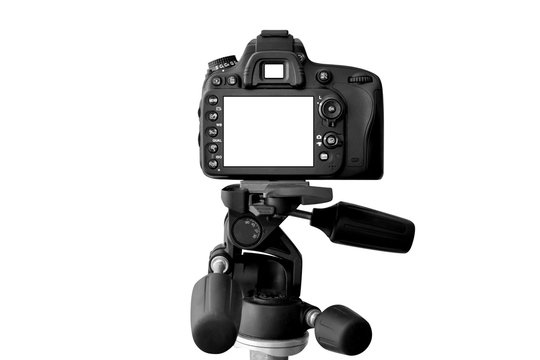Modern Dslr camera with empty screen on tripod, isolated on white background