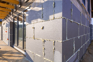 Graphite styrofoam insolation on the new house under construction - obrazy, fototapety, plakaty
