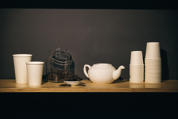 close-up of a set of coffee dishes, round crisp chocolate on a black background