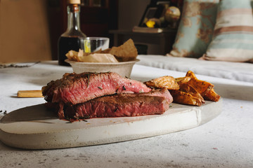 Barbecued steak on cutting board. Sealed with a strong