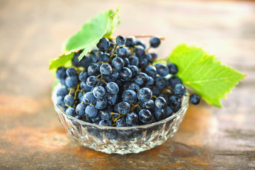 ripe grapes lying in a glass vase