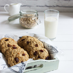 Oatmeal cookies raisin milk glass kitchen table.