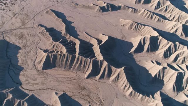 Aerial view of grey sand dunes across the Caineville desert in Utah.