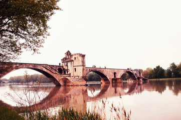 Pont Saint-Benezet. Famous half-ruined medieval bridge of Avignon and its reflection. France....