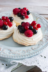 Fresch chic mini pavlova cake kitchen wooden table selective focus