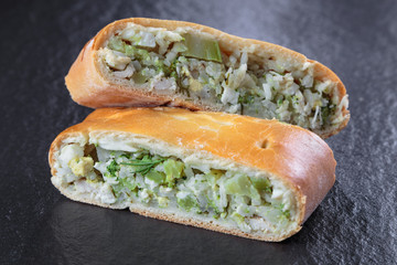  two pieces of pie with filling lie on a black granite surface